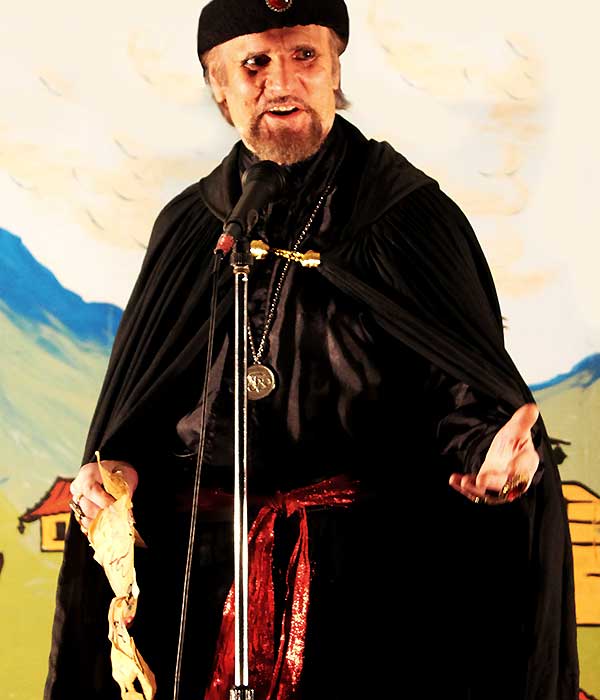 Sean as the menacing Abanazar 2019 close up of sean on stage wearing dark ancient style robes and looking menacing