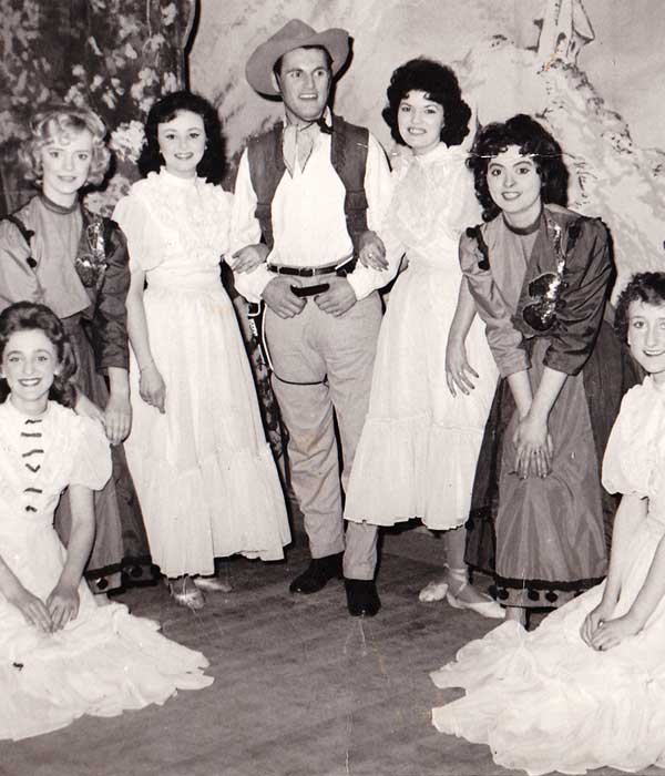 distance view of actor glenn centered on stage surrounded by the cast of blackpools cleveleys theatre